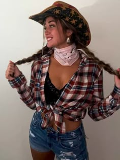 a woman with long hair wearing a pirate hat and bandana is posing for the camera