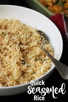 a white bowl filled with rice next to a casserole dish