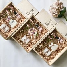 three wooden boxes with flowers in them