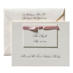 two white envelopes with pink ribbon tied around the front and back of each card