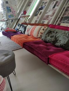 a room filled with lots of different colored couches