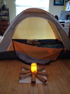 an instagramted photo of a tent on the floor with a candle in it