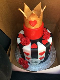 a cake in the shape of a queen's crown with roses and hearts on it