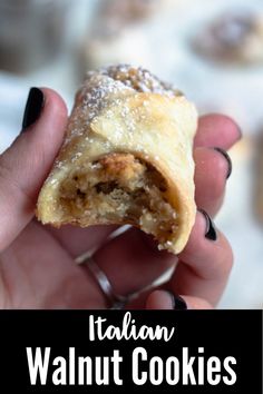 a person holding a pastry in their hand with the words italian walnut cookies on it