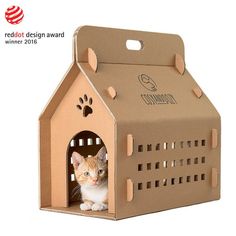 a cardboard cat house with a kitten inside