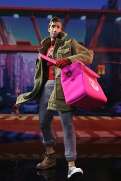 a barbie doll holding a pink handbag