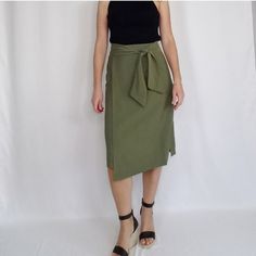 Olive Green Faux Wrap High Waist Midi Skirt Size Small Side Zipper Closure With Waist Tie. 80% Rayon, 20% Polyester All Measurements Are Approximate 14" Waist, 19.75" Hips, 26" Length Chic Olive Bottoms For Spring, Summer Workwear Mini Skirt, Elegant Summer Pencil Skirt For Day Out, Chic Asymmetrical Skirt With Tie Waist, Chic Olive Bottoms For Summer, Spring Tie Waist Midi Wrap Skirt, Chic Fitted Wrap Skirt For Brunch, Spring Asymmetrical Skirt With Tie Waist, Spring Midi Wrap Skirt With Tie Waist