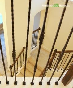 an overhead view of a stair case with wooden railings and handrails on the second floor