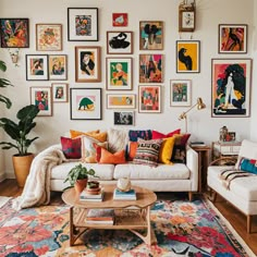 a living room filled with furniture and lots of pictures on the wall above it's coffee table