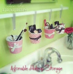 a bathroom sink with toothbrushes and other items hanging on the wall