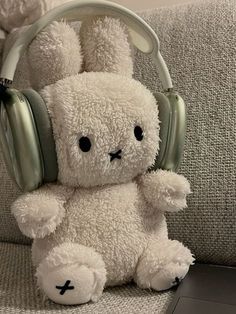 a white stuffed animal with headphones on