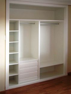 an empty white closet with shelves and drawers