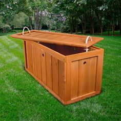 a large wooden storage box in the grass