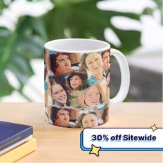 a coffee mug with the faces of many people printed on it, sitting next to a stack of books