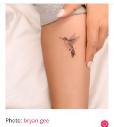 a woman's arm with a hummingbird tattoo on the left side of her thigh