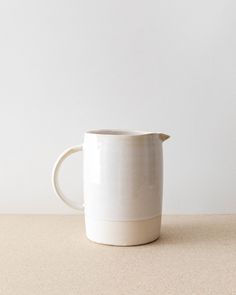 a white mug sitting on top of a table