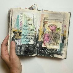 an altered book is held open to show the pages