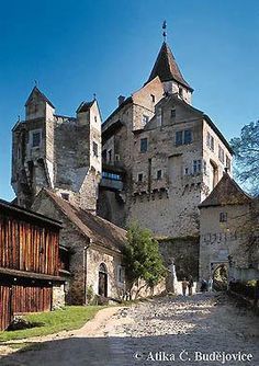 an old castle with stone walls and towers on the top floor is seen in this image