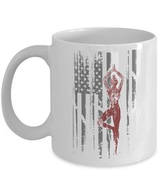 a white coffee mug with an image of a woman doing yoga on the american flag