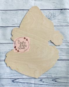 a wooden cutting board with a sticker that says crafty hearts wood on it