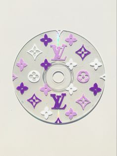 a cd with purple and white stickers on it