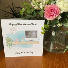 a happy new service year card next to a vase with flowers