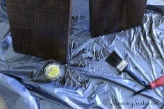 two wooden blocks with paint and brushes on top of tin foil next to each other