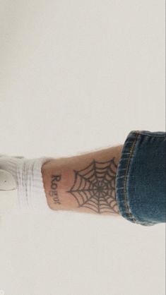 a person with a spider web tattoo on their arm