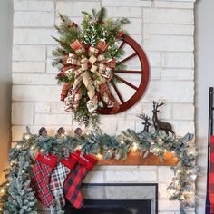 a christmas mantel decorated with stockings and wreaths