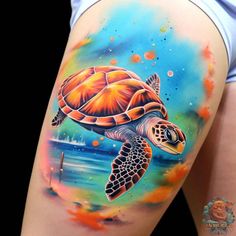 a woman's thigh with a colorful turtle tattoo on the side of her leg