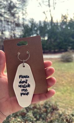 a person holding up a tag with the words please don't watch me pour