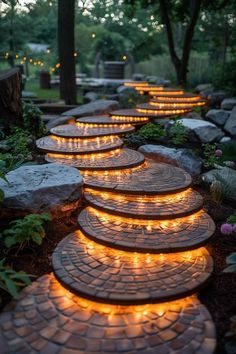 a path made out of stone with lights on it