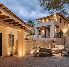 an outdoor living area with patio furniture and lighting