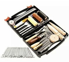 an assortment of kitchen utensils in a black case with wooden spoons and forks