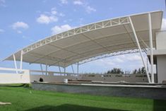 an artist's rendering of the exterior of a sports stadium with grass and benches