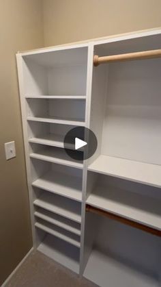 an empty walk in closet with white shelves