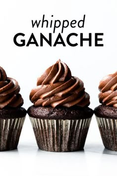 three cupcakes with chocolate frosting in front of the words whipped ganache