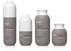 three bottles and two vases with labels on them, all in different shades of gray