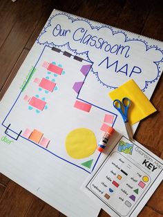 a classroom map with scissors and markers on the table next to it is an activity for kids