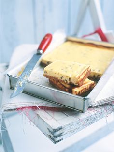 a cutting board with some food on it next to a pair of scissors and napkins