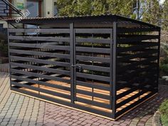 a large metal structure sitting on top of a brick walkway