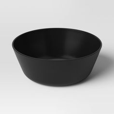 a black bowl sitting on top of a white table