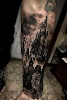 a man's leg with a castle tattoo on it