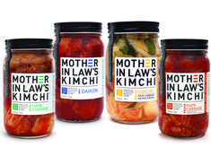 four jars of pickled vegetables with mother in law's kimchi labels on them