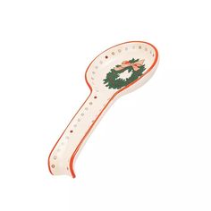 an orange and white spoon with a christmas wreath on it