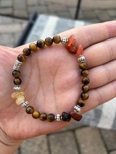 Tiger's eye stretch bracelet, about 7 to 7 1/2 inches but could fit 6 to 8 inch wrists depending on how tight or loose you prefer. Also has citrine, mahogany obsidian, & red agate chips. Natural gemstones, so imperfections can be present. Mahogany Obsidian, Red Agate, Tigers Eye, Tiger's Eye, Nature Bracelets, Stretch Bracelet, Tiger Eye, Stretch Bracelets, Tigers