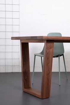 a wooden table with two chairs next to it