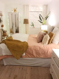 a bed room with a neatly made bed next to a dresser and mirror on the wall