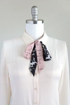 "Black, white, and pink neck scarf in a shadow bouquet/face print mix. Ready to ship, special edition midi-length skinny scarf designed by Cinne. Full of character with endless styling possibilities. Wear around your neck, in your hair, tied on your favorite bag, or around your wrist. Find more styling examples in second to last photo. Constructed entirely by hand with love and attention to every detail. . . . . . . . . . . . . . . . . . . . . . . . . . . . . . . . . . . . . . . . . . . . . . . Trendy Spring Scarves, Black Silk Scarf As Summer Gift, Black Silk Scarf For Summer Gift, Trendy Scarves For Spring Workwear, Trendy Spring Scarves For Workwear, Trendy Pink Scarves One Size, Adjustable Scarf Neckwear For Spring, Chic Pink Scarf As Gift, Chic Black Silk Scarf Gift