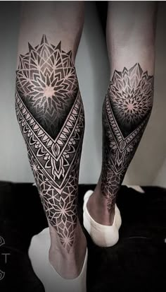 the legs and ankles are covered in intricate tattoos, like this one on a woman's leg